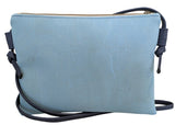 Cork leather crossbody bag with a dark blue strap on a blue background