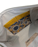 Inside tan lining with yellow and blue daisy 4 card holder and cork label